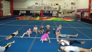 children sitting in gymnastics gym